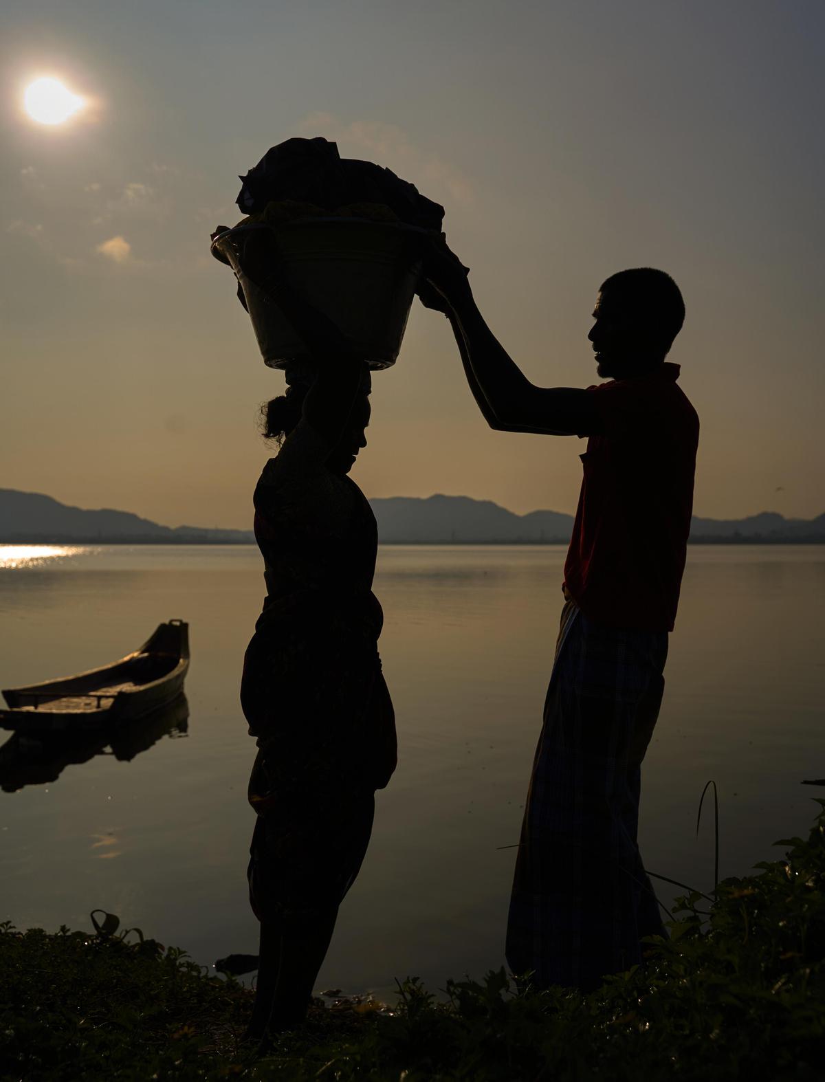 Image of Atmospheric phenomenon, Sky, Water, Reflection, Standing, Silhouette etc.